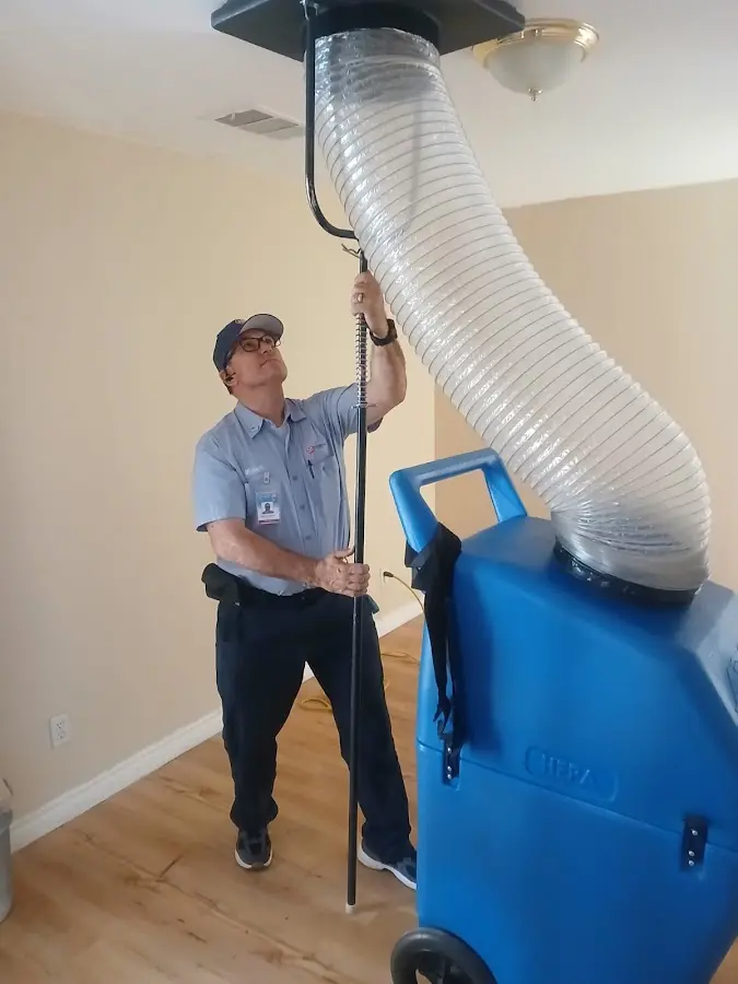 Furnace Tune-Up technician using HEPA equipment in Arvada